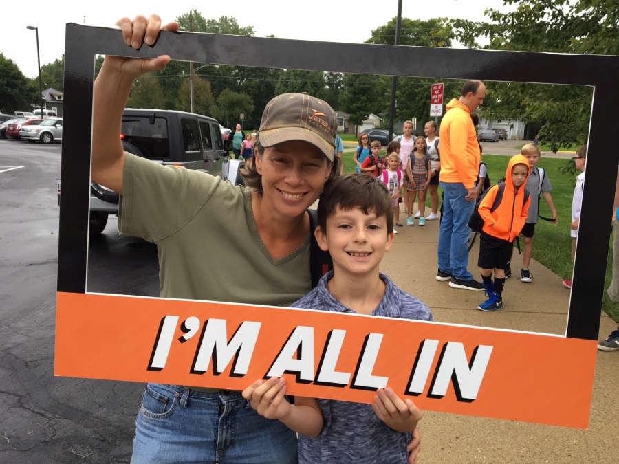 people holding a frame sign